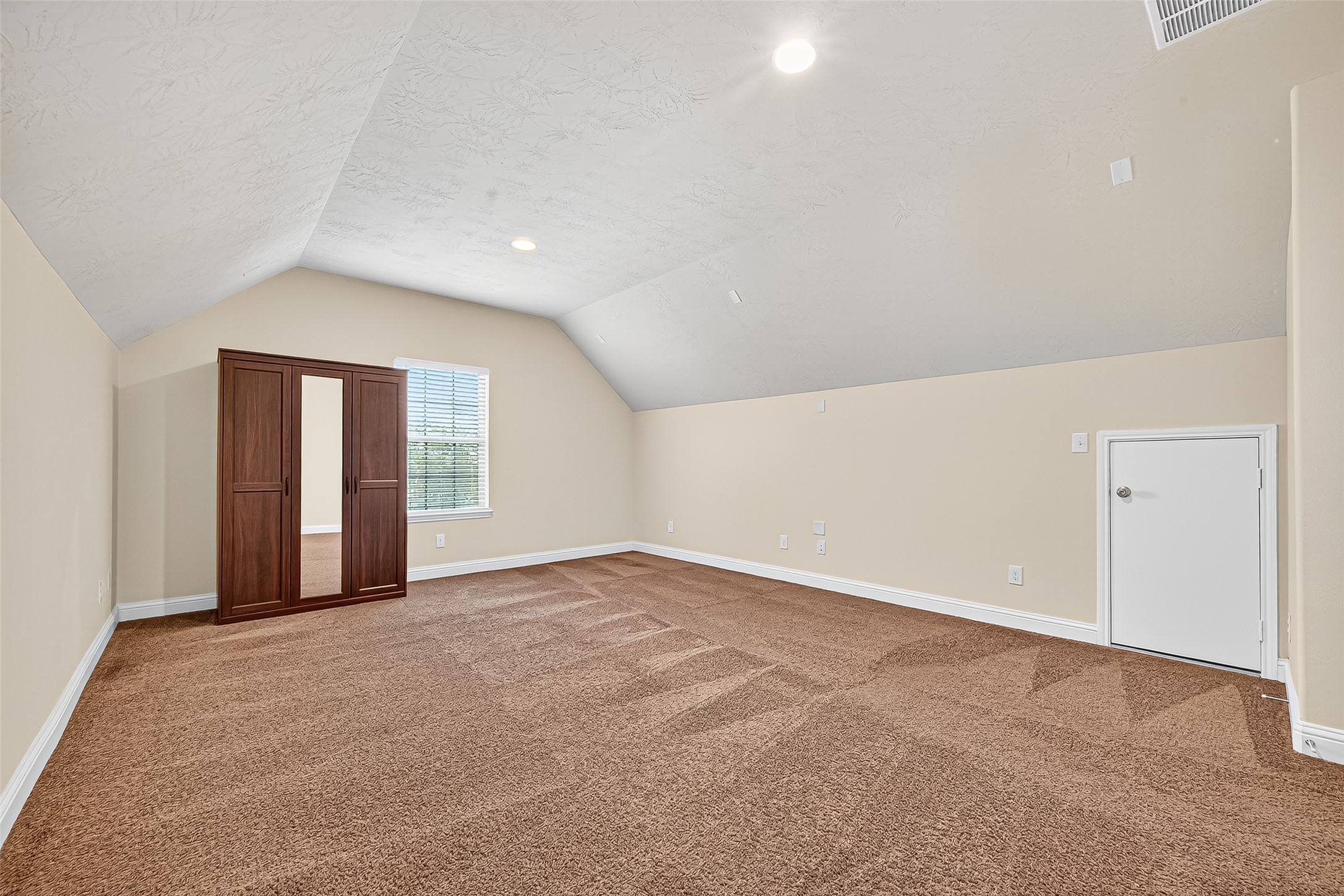 8107 Lockridge Terrace Lane Cypress, TX 77433 - Photo 38 of 50 This spacious upstairs room, originally designed as a media room, offers endless potential—whether you're envisioning a private home theater, playroom, or ultimate entertainment space. With its vaulted ceilings and double-door entry, it’s the perfect retreat to relax, unwind, and make lasting memories.