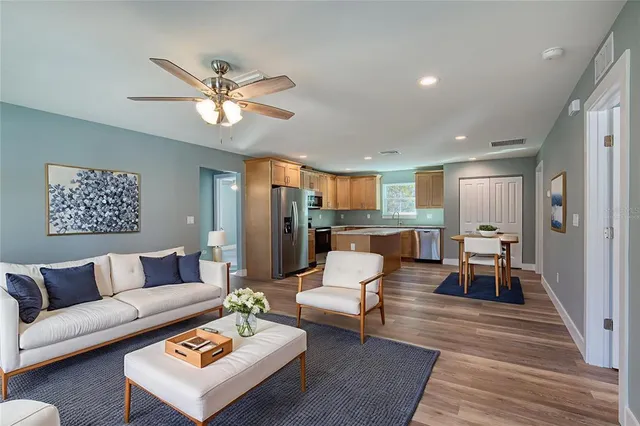 a living room with furniture and wooden floor