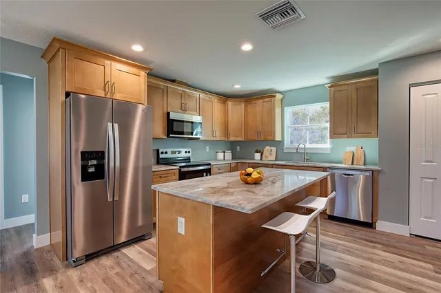 a kitchen with refrigerator cabinets dining table and chairs