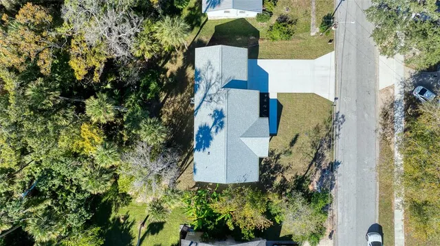 an aerial view of a house with a yard and garden
