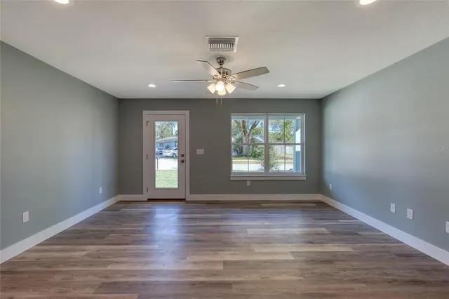 wooden floor in an empty room with a window