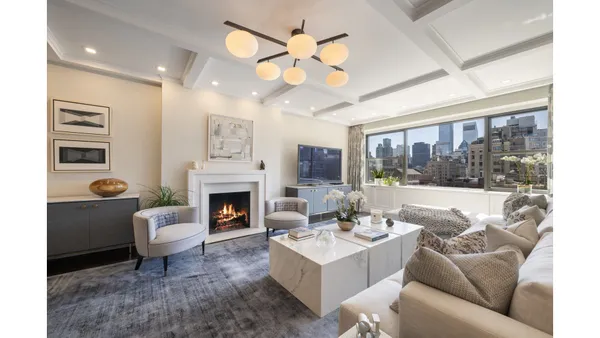 a living room with furniture a fireplace and a large window with outer view