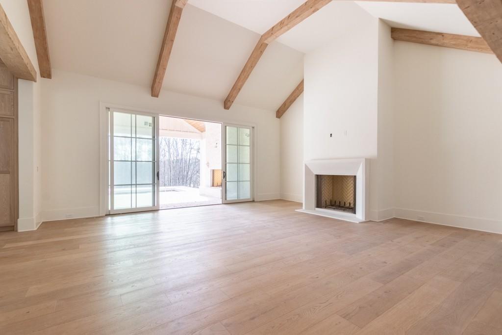 615 Hickory Flat Road Milton, GA 30004 - Photo 14 of 64 a view of an empty room with a fireplace and a window