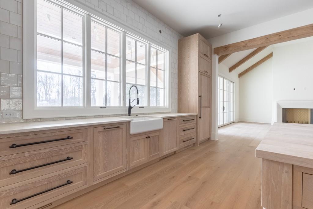 615 Hickory Flat Road Milton, GA 30004 - Photo 23 of 64 a large white kitchen with granite countertop a large window and a sink