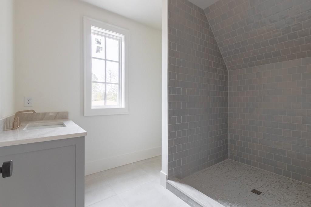 615 Hickory Flat Road Milton, GA 30004 - Photo 57 of 64 a bathroom with a granite countertop sink a mirror and a bathtub