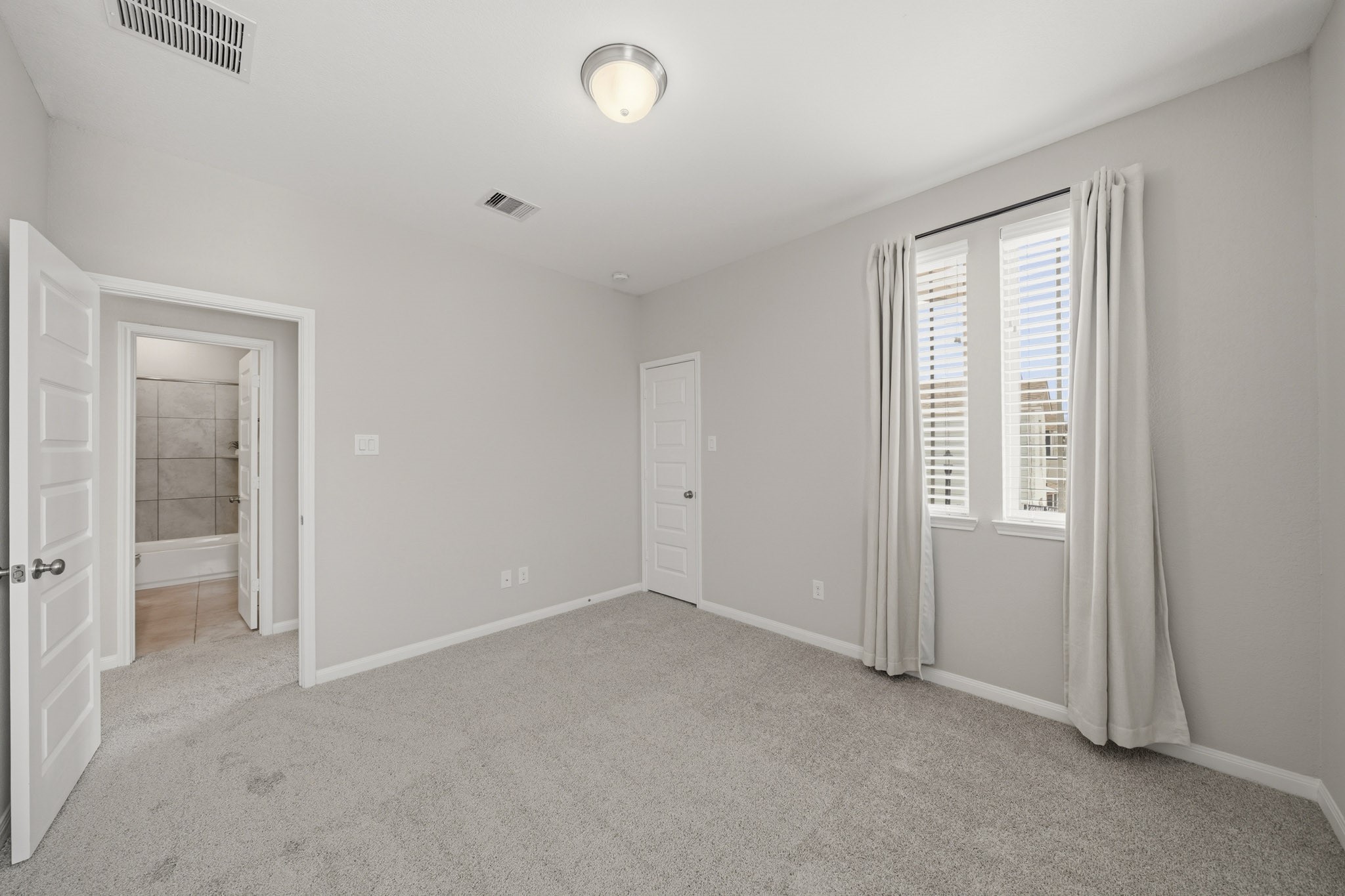 4103 Tranquil Square Road Houston, TX 77043 - Photo 27 of 39 Light-filled secondary bedroom offering a comfortable retreat accented by classic blinds, drapery, a light overhead and closet. The second bath sits just outside this bedroom.