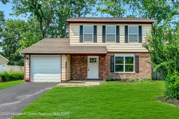 a view of house with backyard space and garden