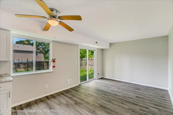 a kitchen with stainless steel appliances granite countertop a stove a refrigerator and a white cabinets