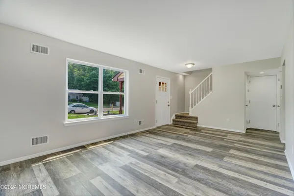 a view of house with backyard space and garden