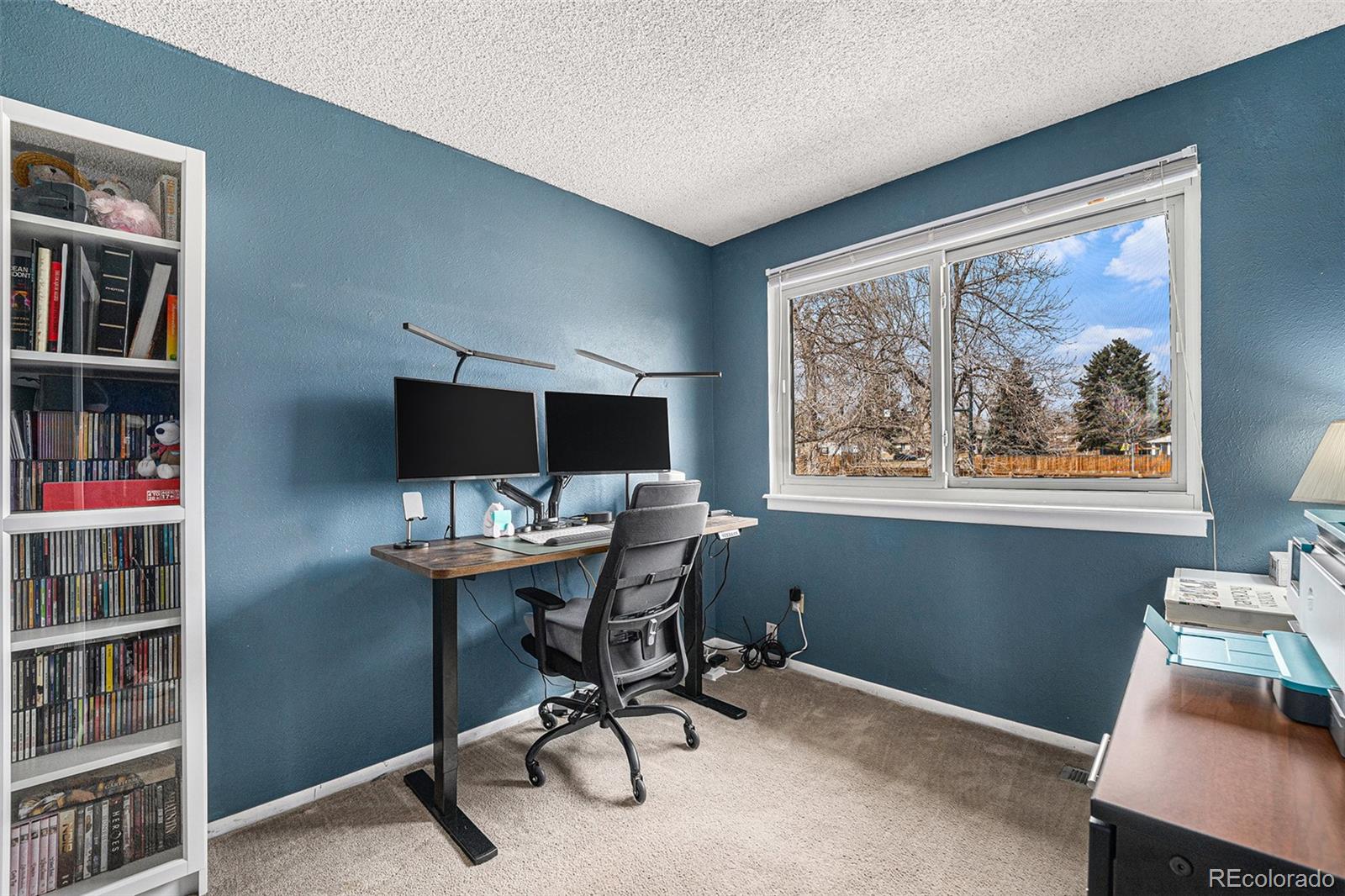 8746 Carr Loop Arvada, CO 80005 - Photo 17 of 22 a view of a workspace with furniture and a window