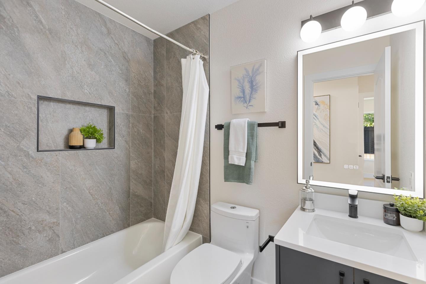 262 Checkers Drive San Jose, CA 95116 - Photo 12 of 17 a bathroom with a sink a toilet and shower