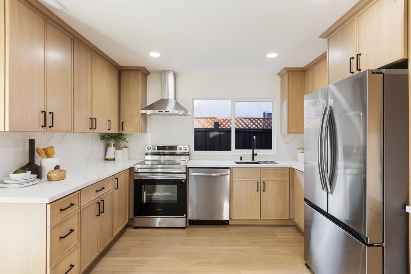 262 Checkers Drive San Jose, CA 95116 - Photo 5 of 17 a kitchen with stainless steel appliances a refrigerator sink and cabinets
