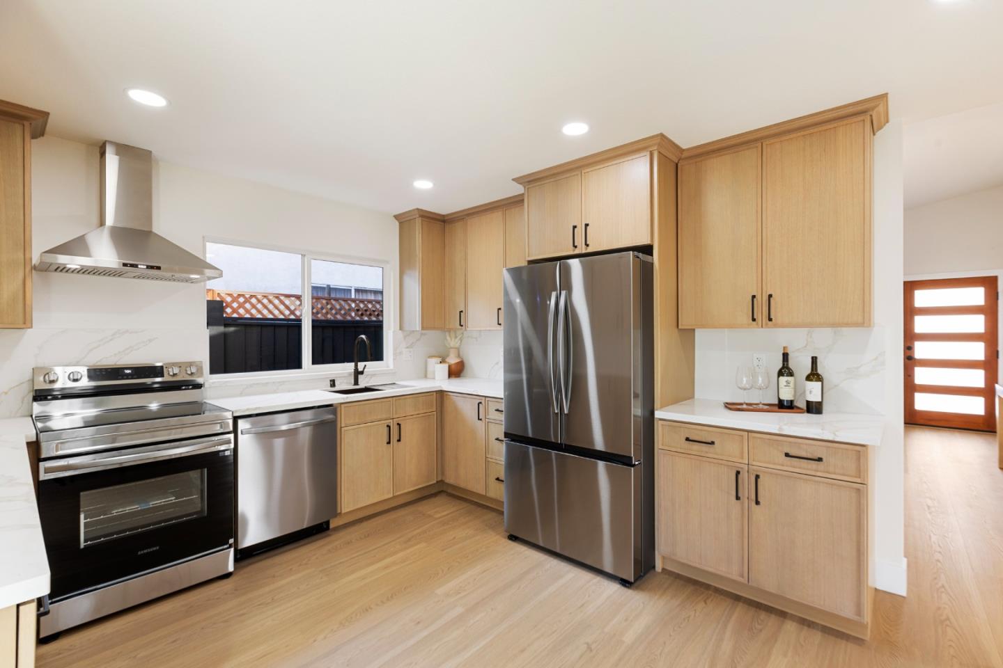 262 Checkers Drive San Jose, CA 95116 - Photo 6 of 17 a kitchen with cabinets stainless steel appliances and wooden floor