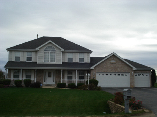 10694 Chicory Ridge Way Roscoe, IL 61073 - Photo 1 of 11 a front view of a house with a garden and yard