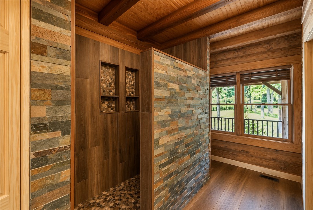 414 Devon Way Anderson, SC 29621 - Photo 17 of 50 Experience rustic refinement in this uniquely crafted shower, offering natural stone and wood accents with a serene outdoor vista.