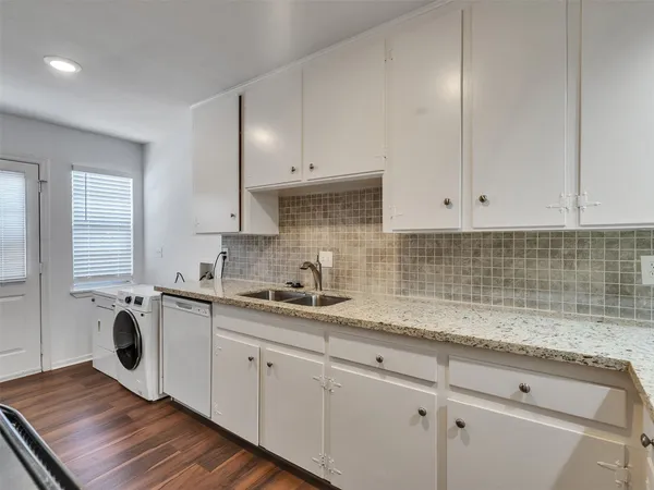 a kitchen with stainless steel appliances granite countertop a sink stove and cabinets