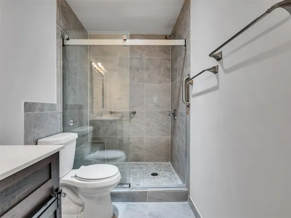a bathroom with a shower and a toilet
