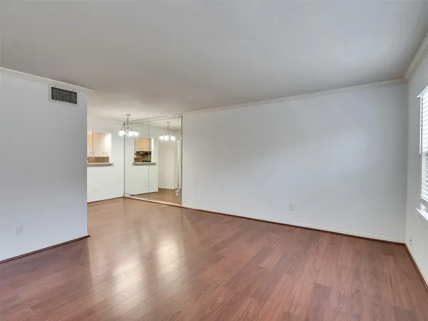 a view of an empty room and wooden floor