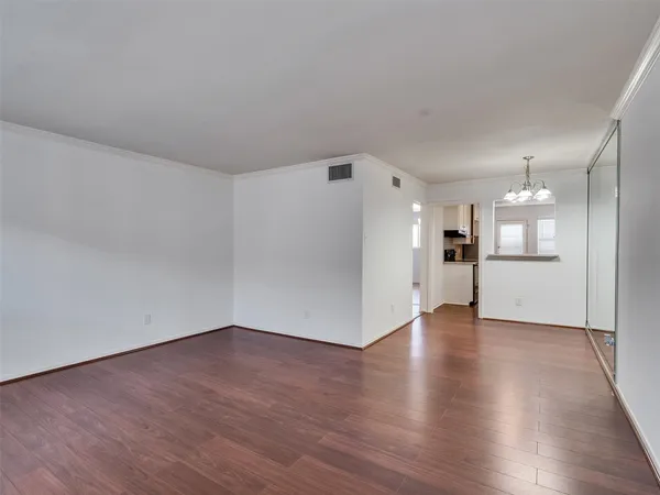 a view of a kitchen with wooden floor and a kitchen
