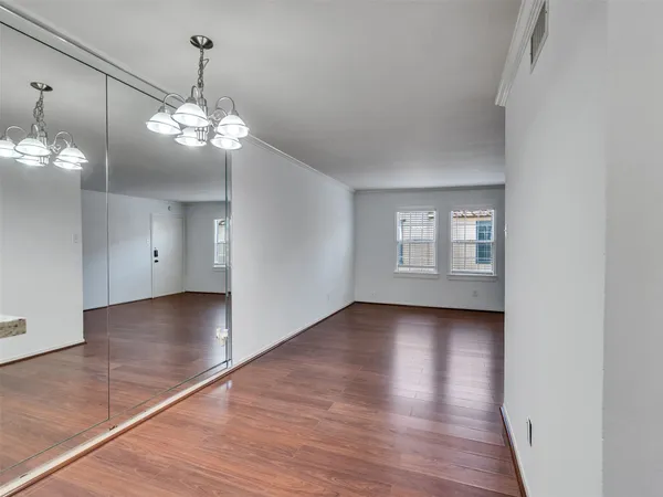 a view of a livingroom with a ceiling fan window and wooden floor