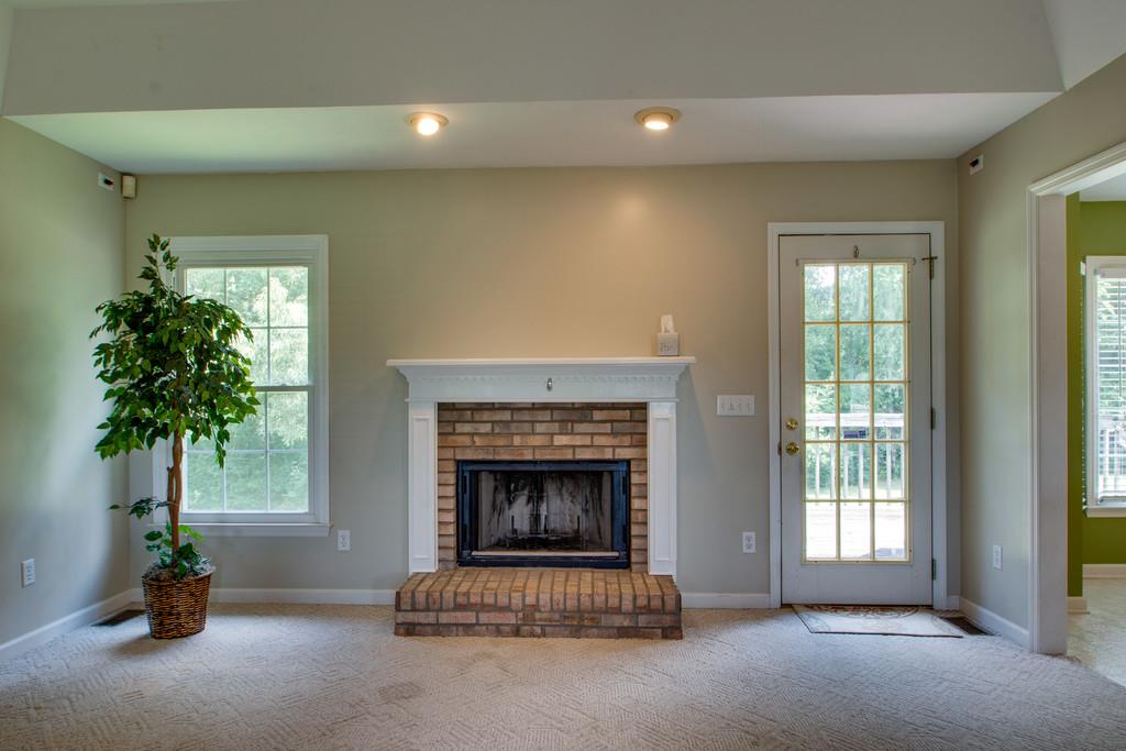 7342 Taylor Road Fairview, TN 37062 - Photo 17 of 17 Recessed lighting, brick fireplace and access to the deck. This floor plan flows really well and is perfect for entertaining or for memorable family holiday gatherings.