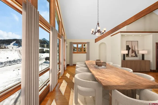 a dining room with a large window table and chairs