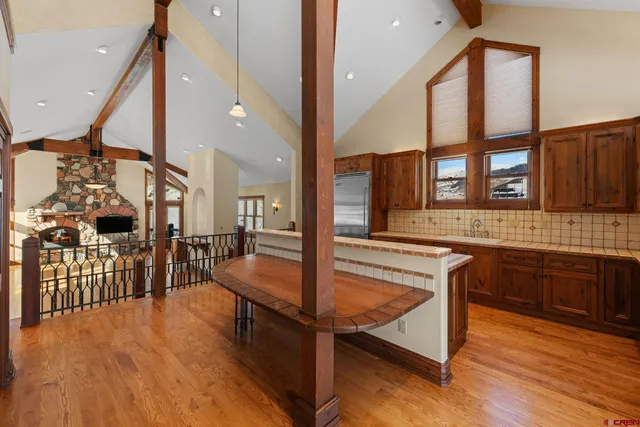 a view of a living room kitchen and a wooden floor