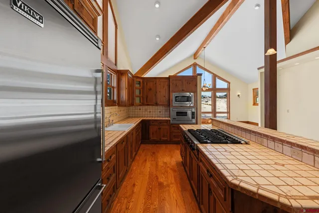 a kitchen with stove and cabinets