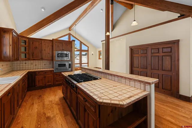 a kitchen with a stove and a kitchen island