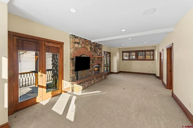 a view of an empty room with a fireplace and a window