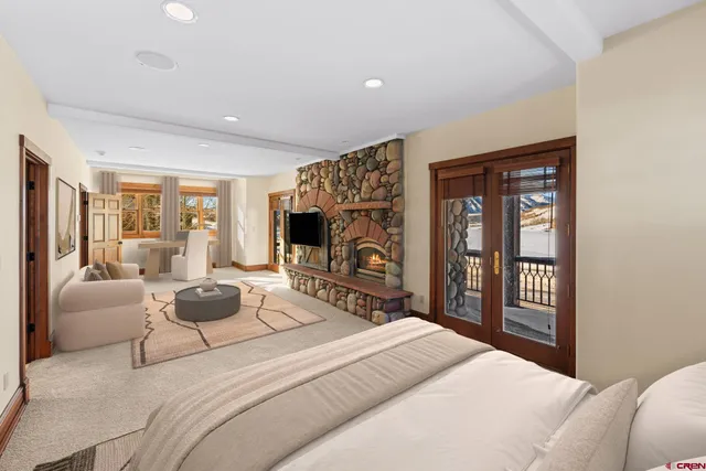 a bedroom with a balcony a bed and a flat screen tv