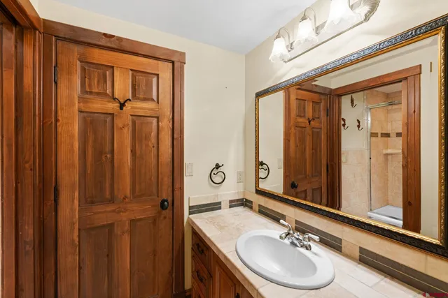a bathroom with a sink double vanity and a mirror