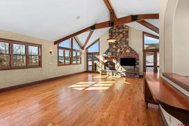 a living room with furniture and a floor to ceiling window