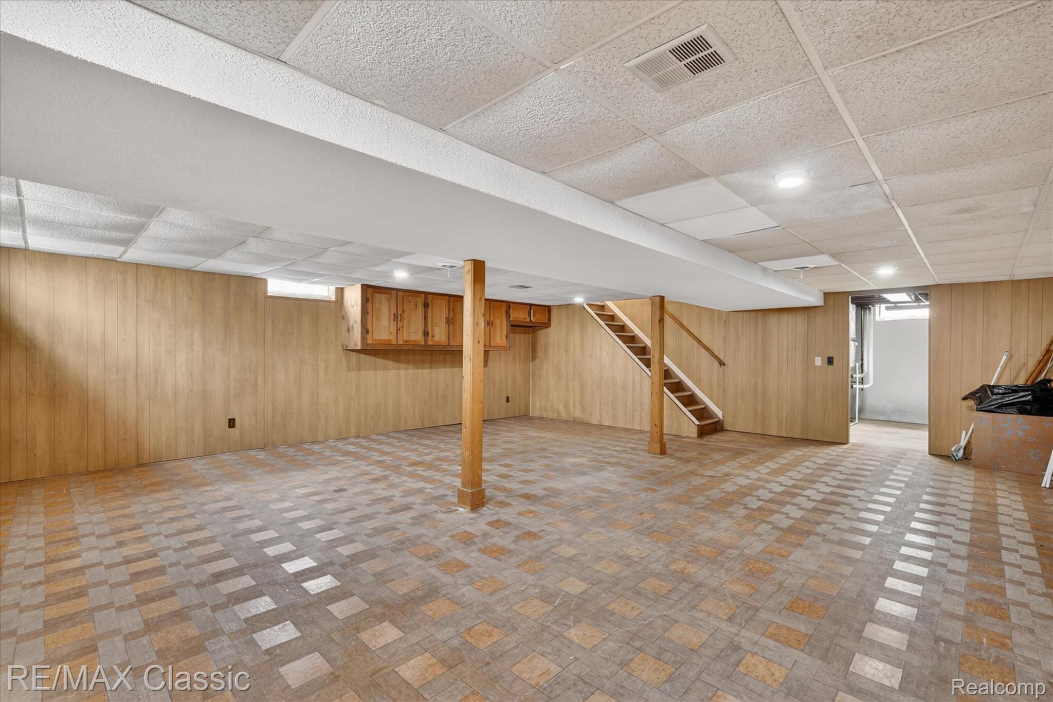 5060 Warmbriar Road White Lake, MI 48383 - Photo 21 of 34 Finished below grade area with a drop ceiling, wooden walls, and recessed lighting