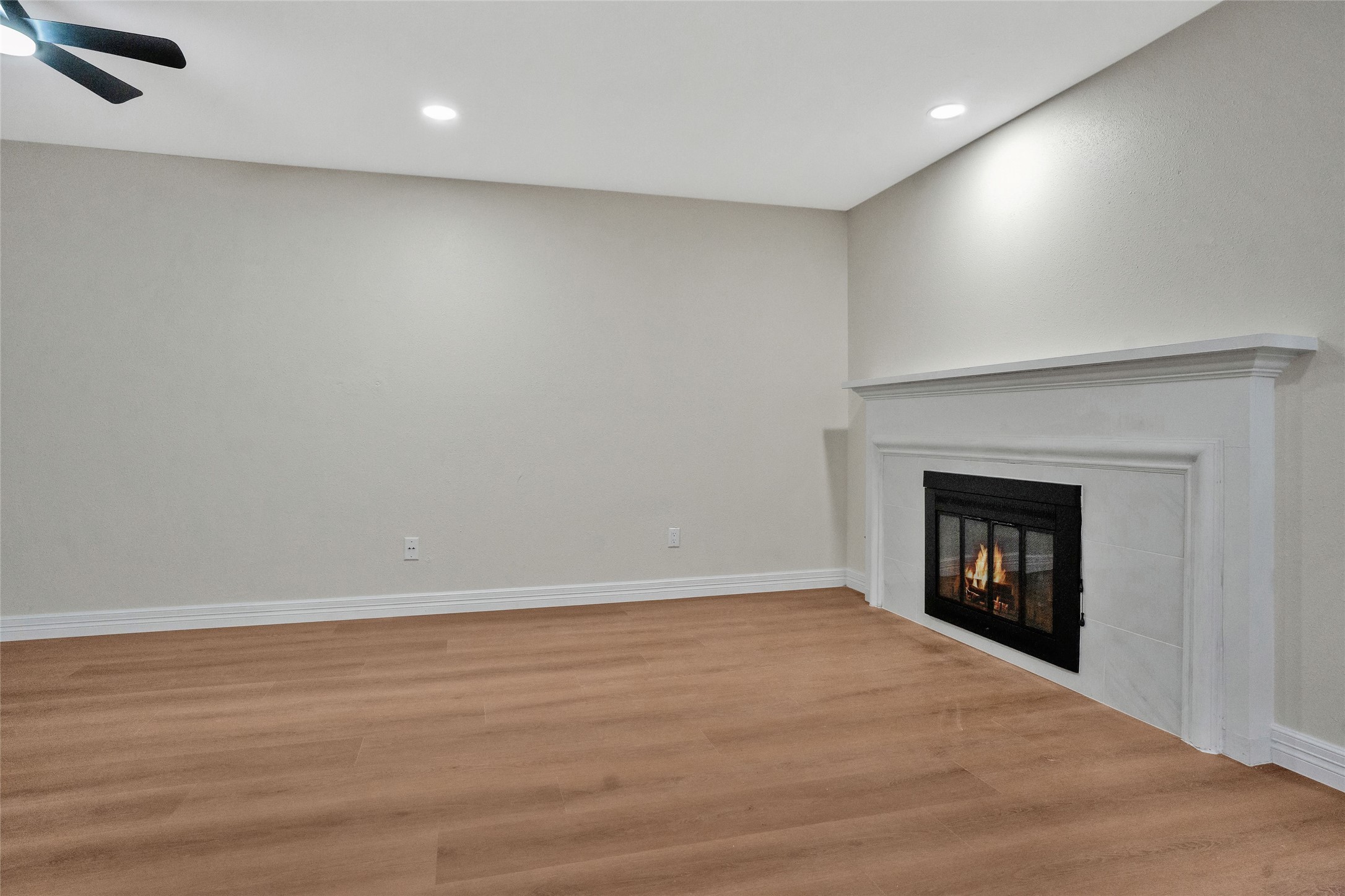 3 Still Corner Place Spring, TX 77381 - Photo 15 of 41 Cozy fireplace anchoring the living space, adding warmth and character while remaining open to the surrounding living and dining areas.