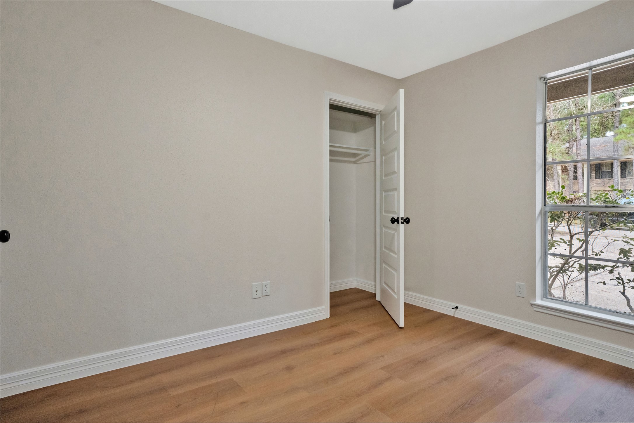 3 Still Corner Place Spring, TX 77381 - Photo 26 of 41 Front-facing bedroom with updated flooring, neutral paint, and closet storage, ideal for a guest room, nursery, or private home office.