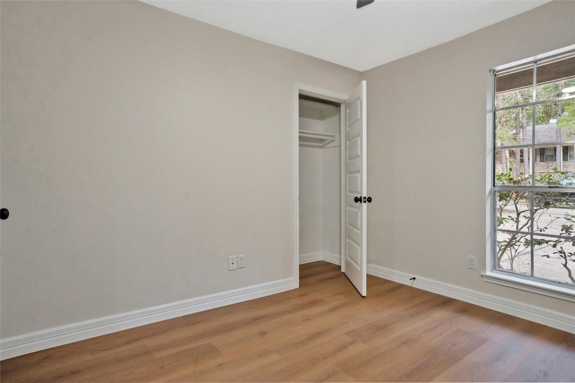 3 Still Corner Place Spring, TX 77381 - Photo 26 of 42 Front-facing bedroom with updated flooring, neutral paint, and closet storage, ideal for a guest room, nursery, or private home office.