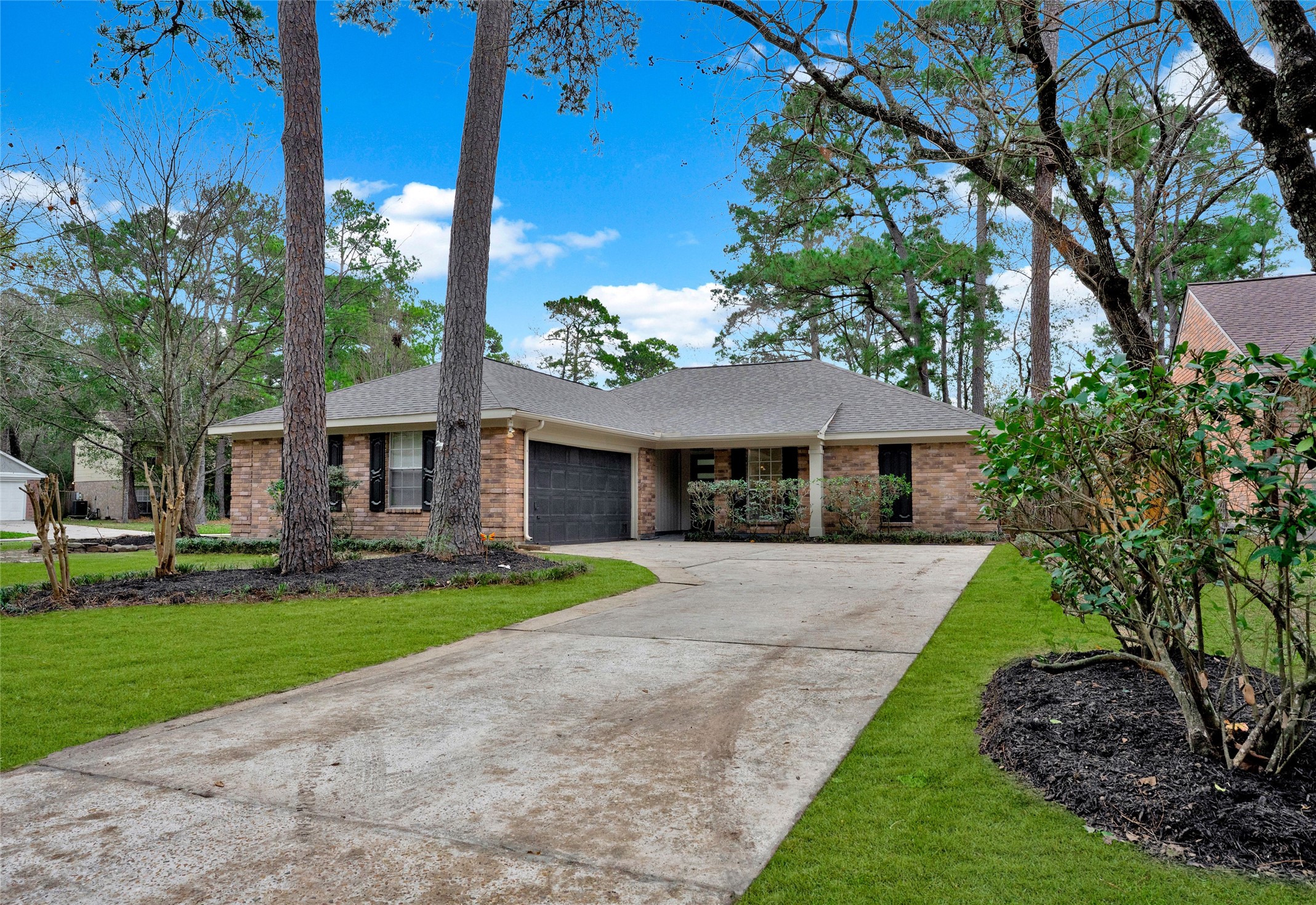 3 Still Corner Place Spring, TX 77381 - Photo 40 of 41 Extended driveway provides ample parking and easy access, framed by established trees and well-maintained exterior features.