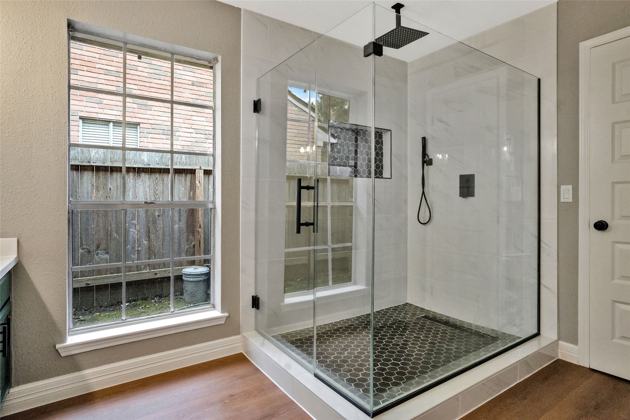 3 Still Corner Place Spring, TX 77381 - Photo 8 of 41 Stunning primary bathroom featuring an oversized walk-in shower with frameless glass enclosure, waterfall shower head, and sleek tile finishes.