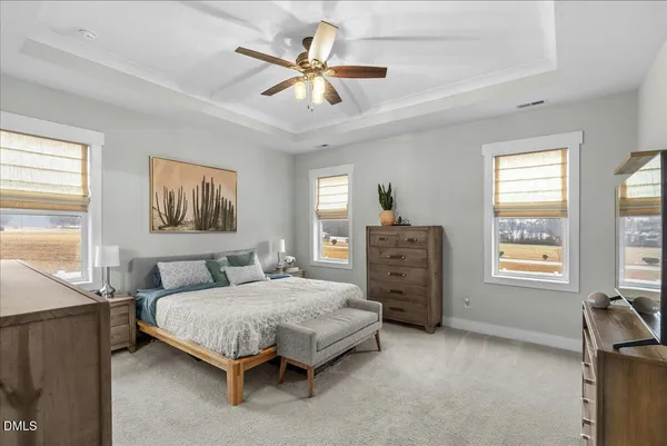 a bedroom with a bed a dresser and a window