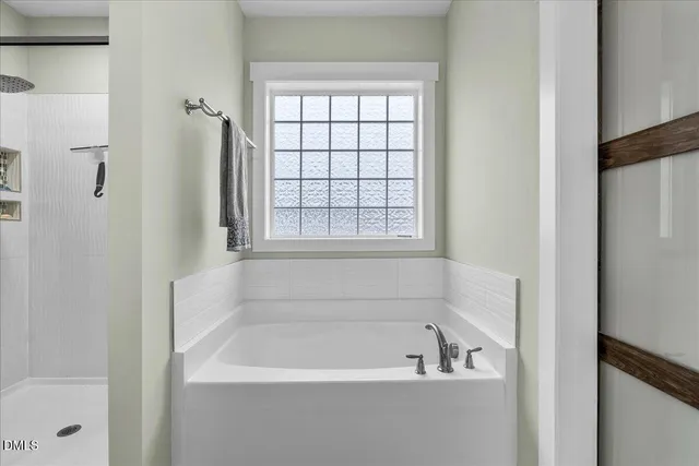 a white bath tub sitting next to a window