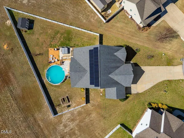 a view of a balcony with wooden floor and a potted plant