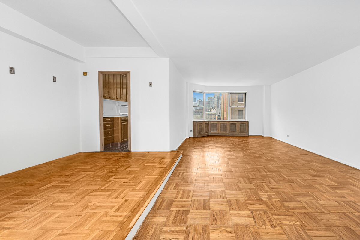 215 East 79th Street, Unit 12B Manhattan, NY 10075 - Photo 3 of 11 a view of empty room with wooden floor