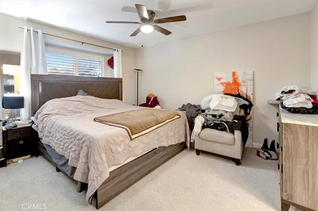 a spacious bedroom with a bed and a chandelier