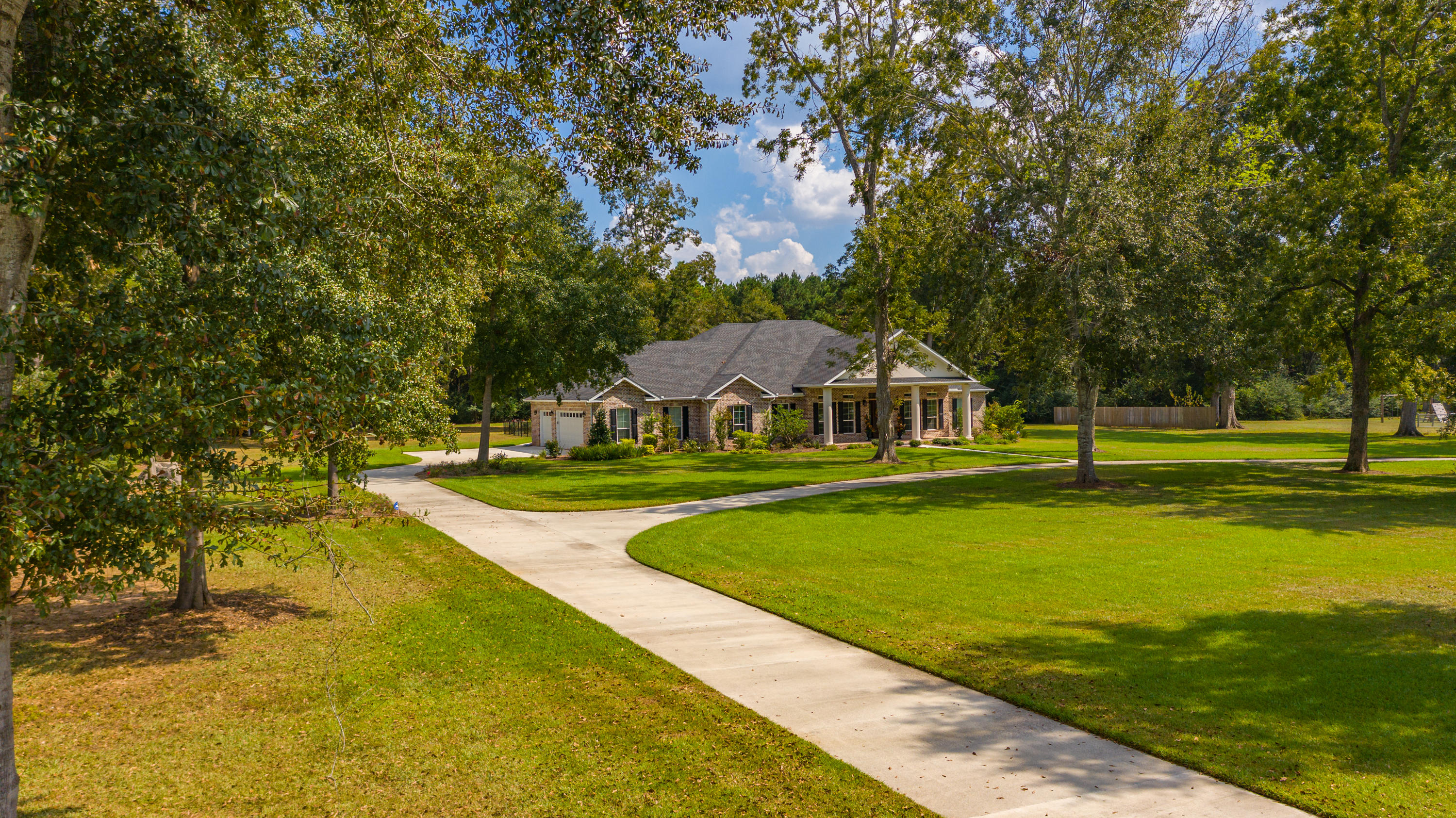 5973 Jack Stokes Road Baker, FL 32531 - Photo 54 of 61 a view of a house with swimming pool and yard with green space