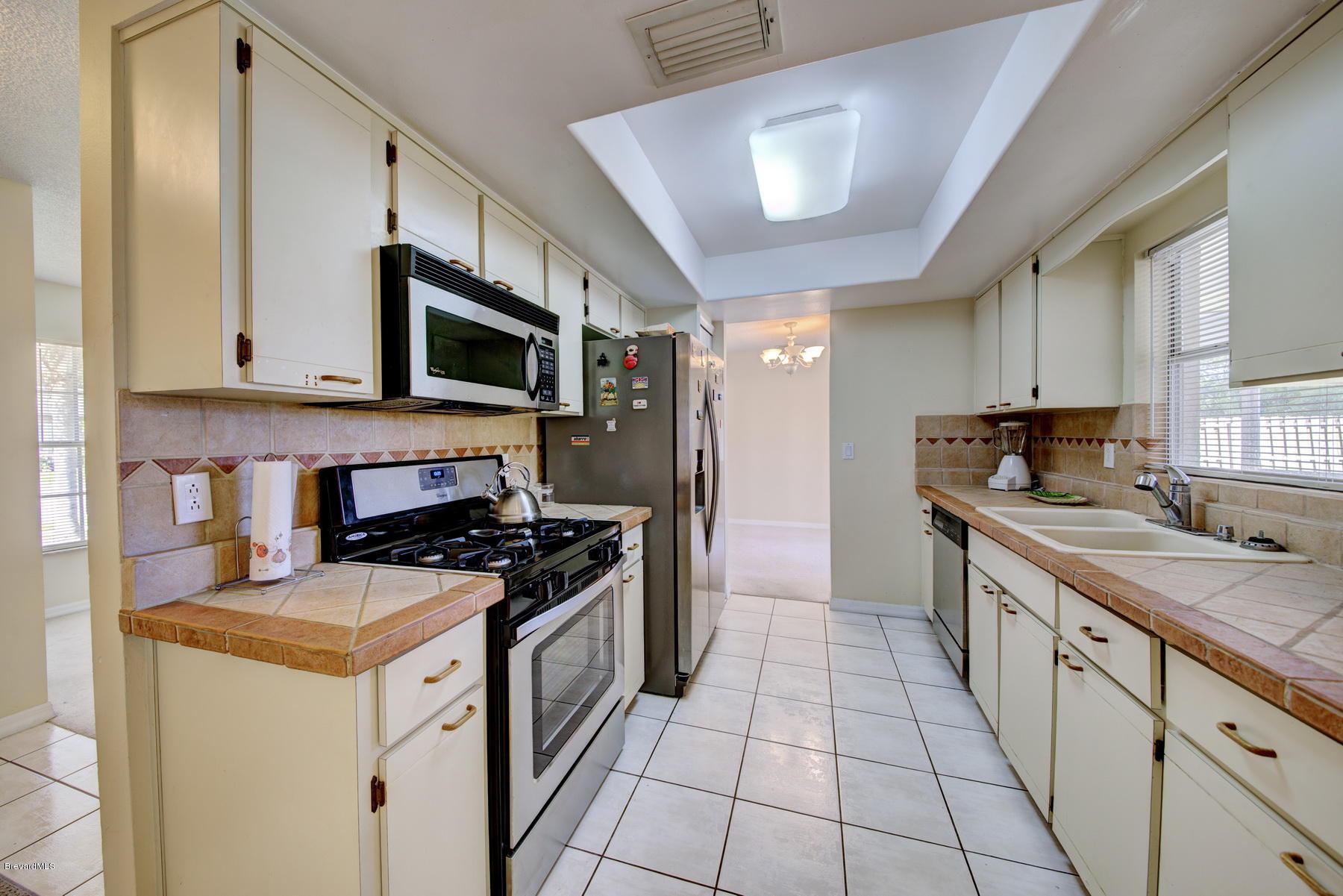 162 Crystal Lake Road Melbourne, FL 32901 - Photo 4 of 11 a kitchen with a stove sink and a microwave