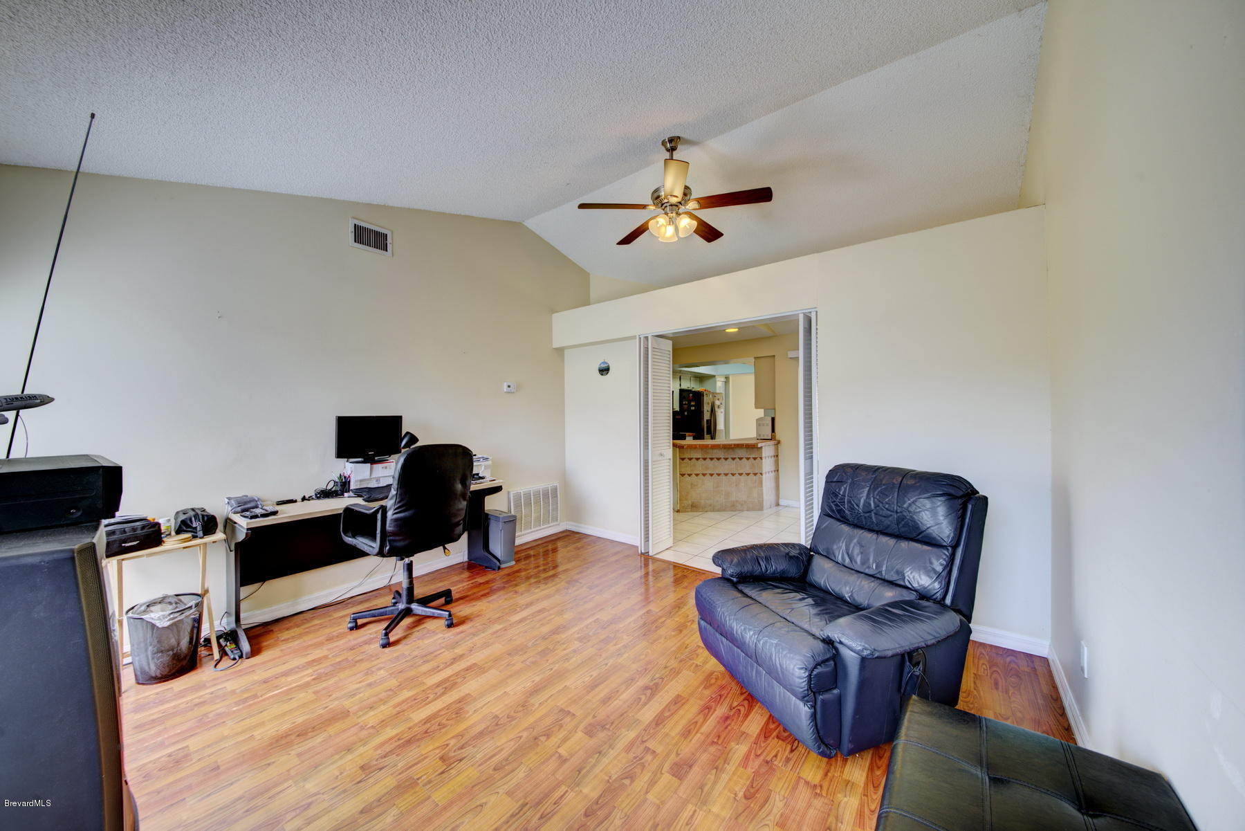 162 Crystal Lake Road Melbourne, FL 32901 - Photo 5 of 11 a view of a workspace with furniture and a window