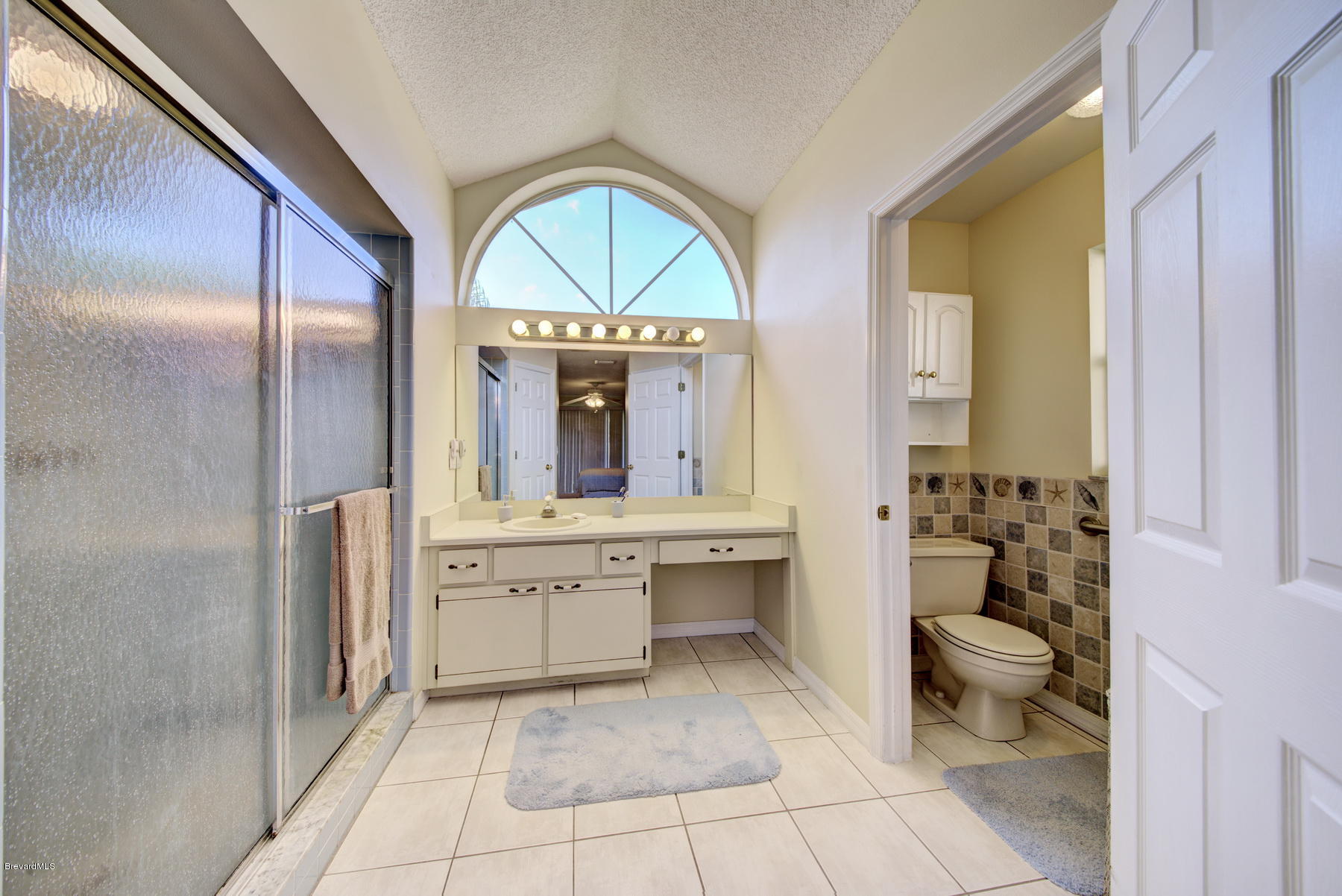 162 Crystal Lake Road Melbourne, FL 32901 - Photo 6 of 11 a bathroom with a tub mirror and toilet