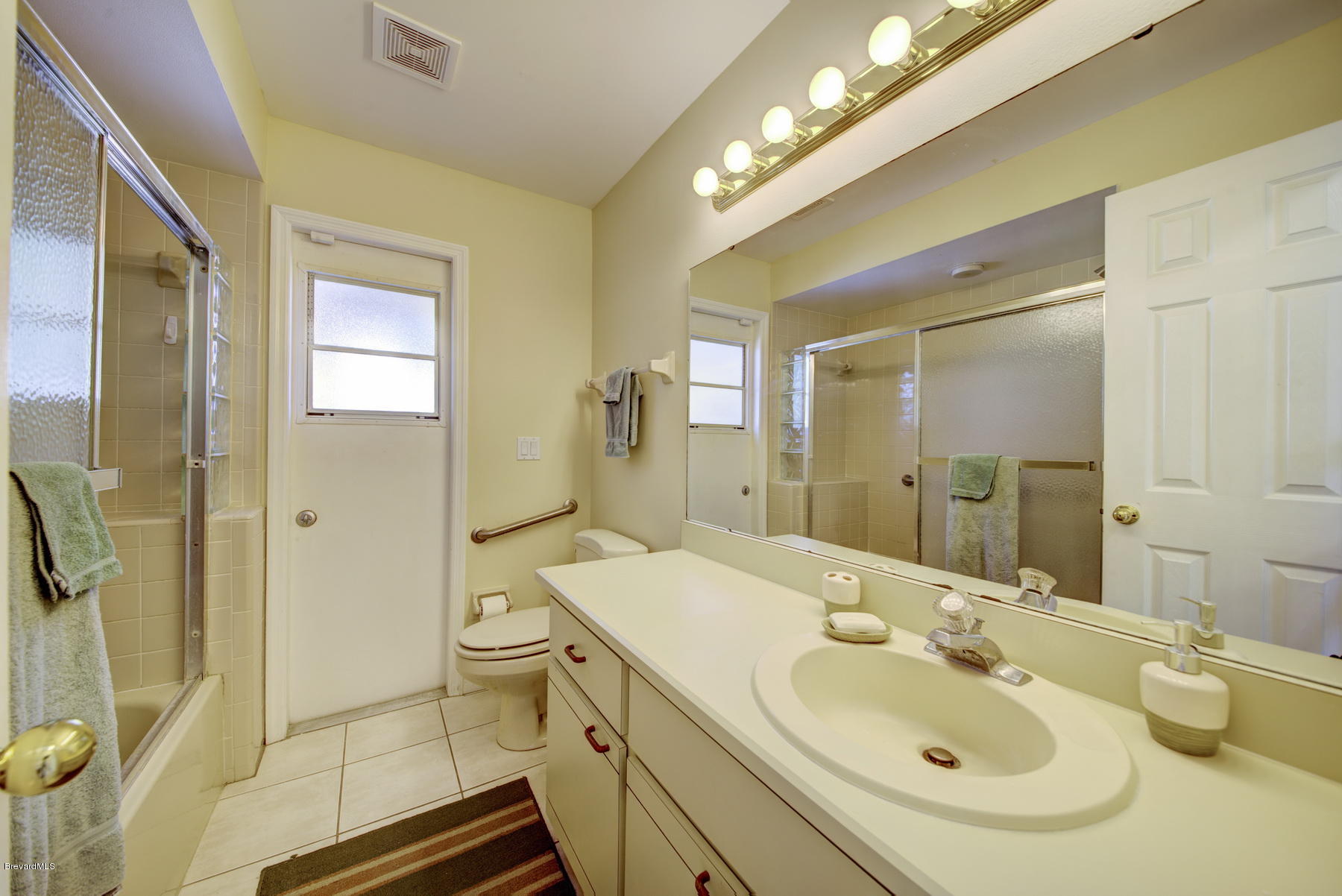 162 Crystal Lake Road Melbourne, FL 32901 - Photo 8 of 11 a bathroom with a sink a toilet and shower