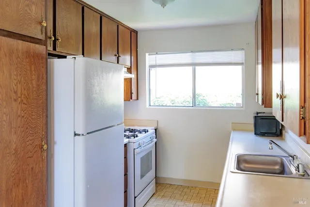 a kitchen with a stove a sink and a refrigerator
